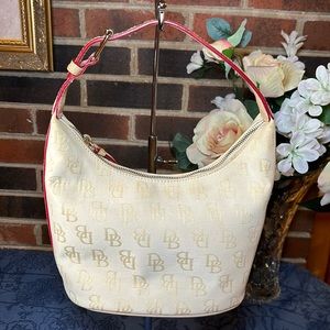 Dooney and Bourke small pale yellow signature bag. 8"L x 8"H x 5.5"W  EUC